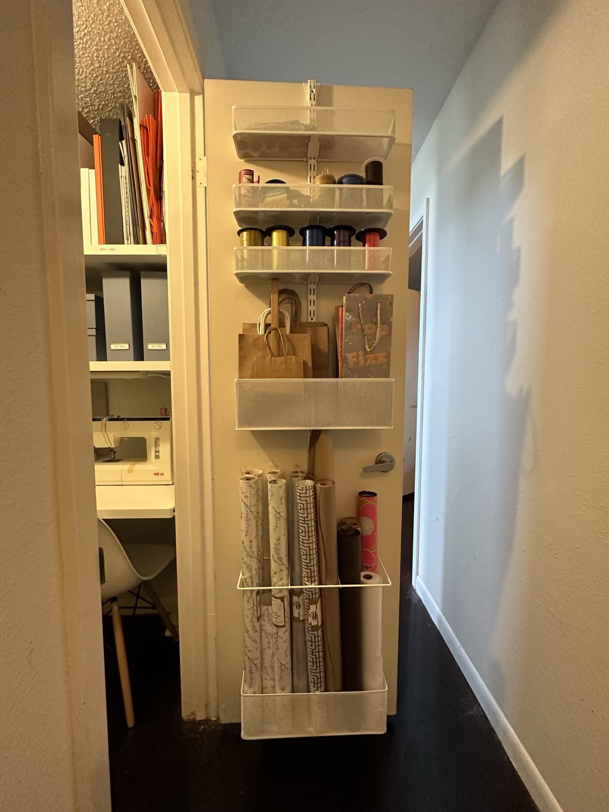 Narrow craft closet with vertical storage for wrapping paper, ribbon and ongoing projects
