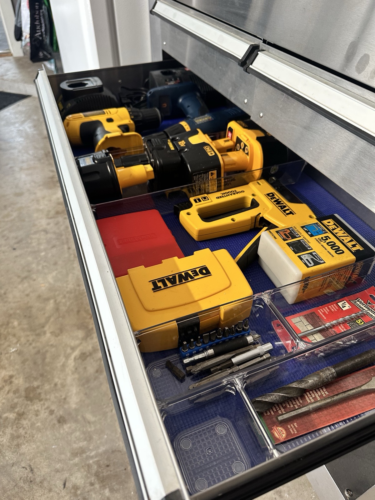 Garage tool drawer with clear dividers separating drills, bits and hardware, organized by Refinery ATX in Austin, TX