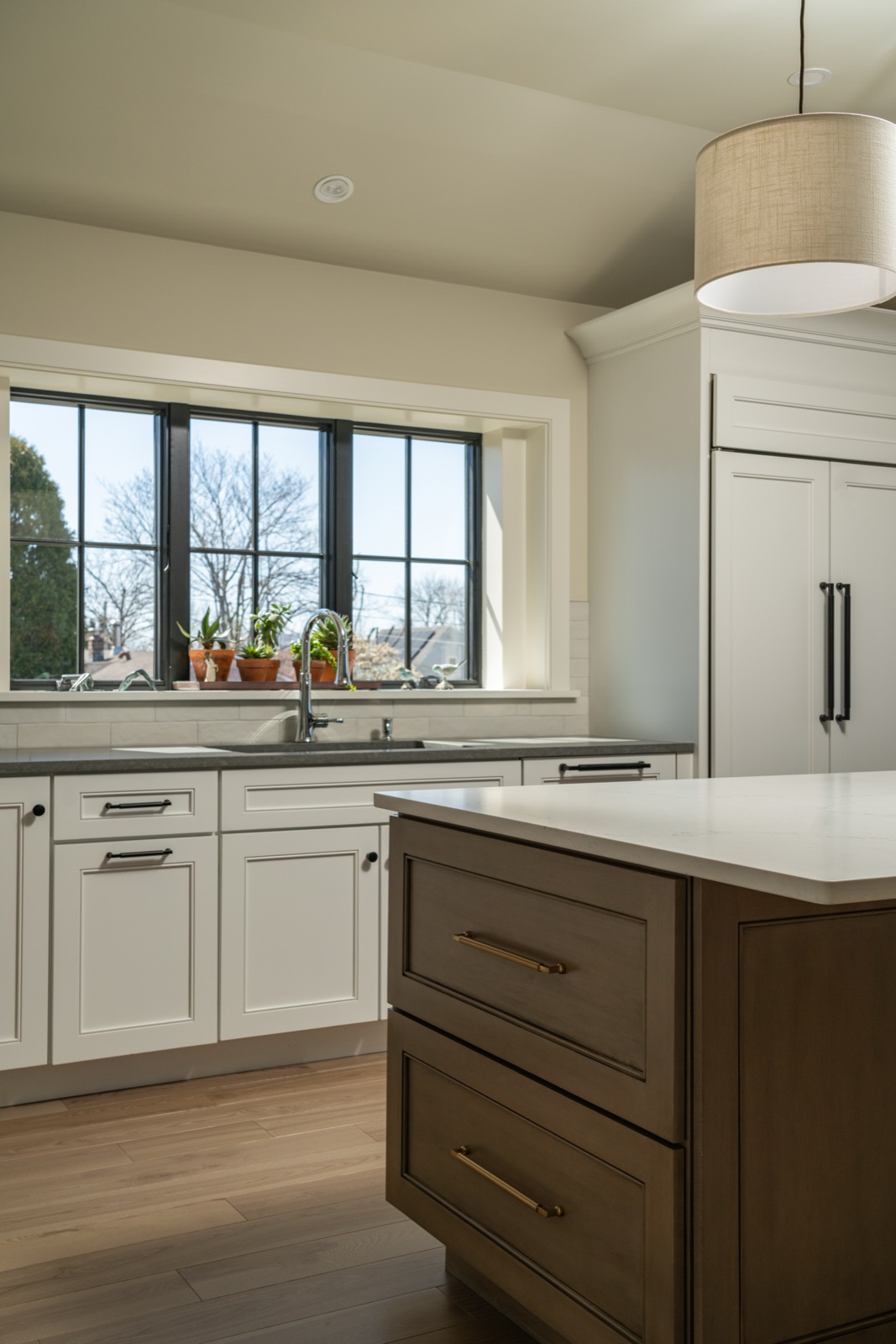 Custom white kitchen with natural light and open shelving, interior design by Refinery ATX