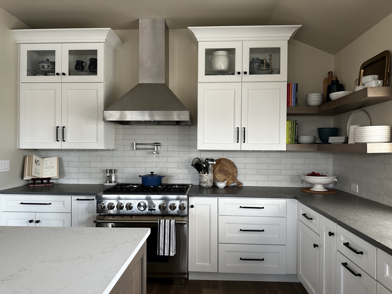 White kitchen with professional range and open shelving organized by Refinery ATX