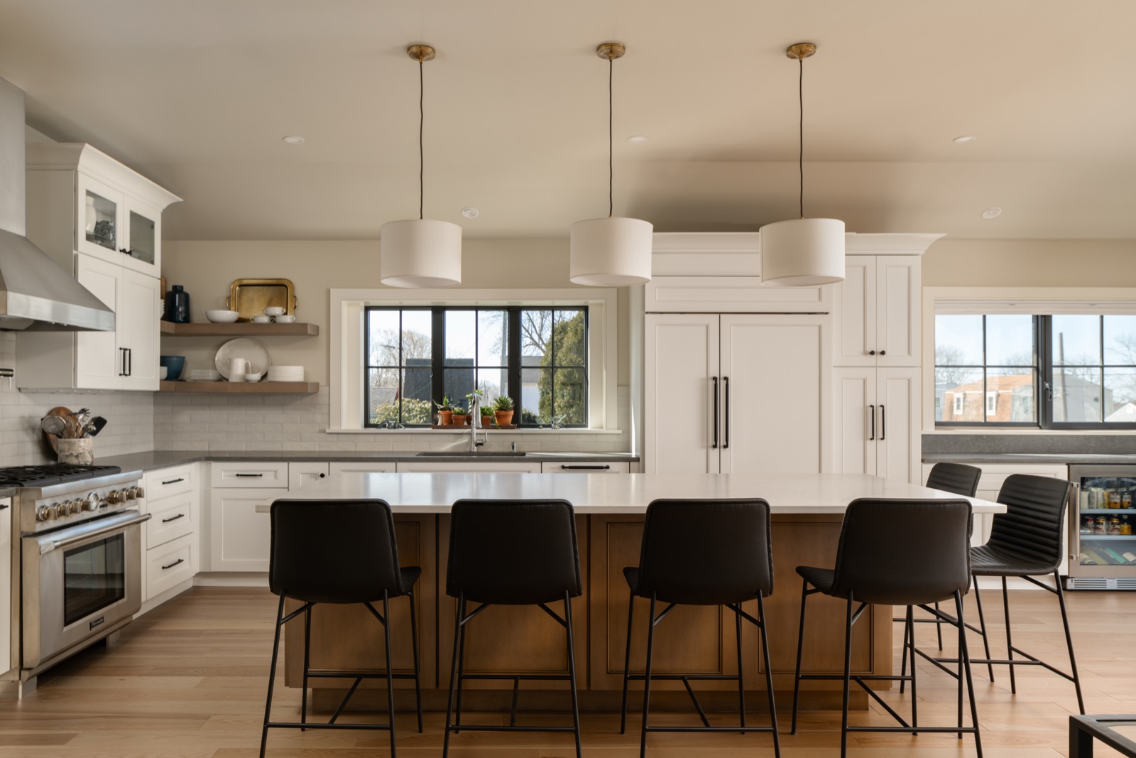 White kitchen with island seating for six, interior design by Refinery ATX